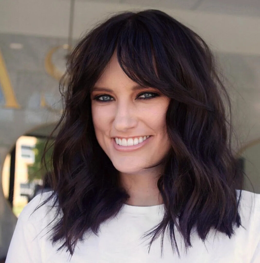 Cute and Wavy: Styles with Bangs for Thick Hair