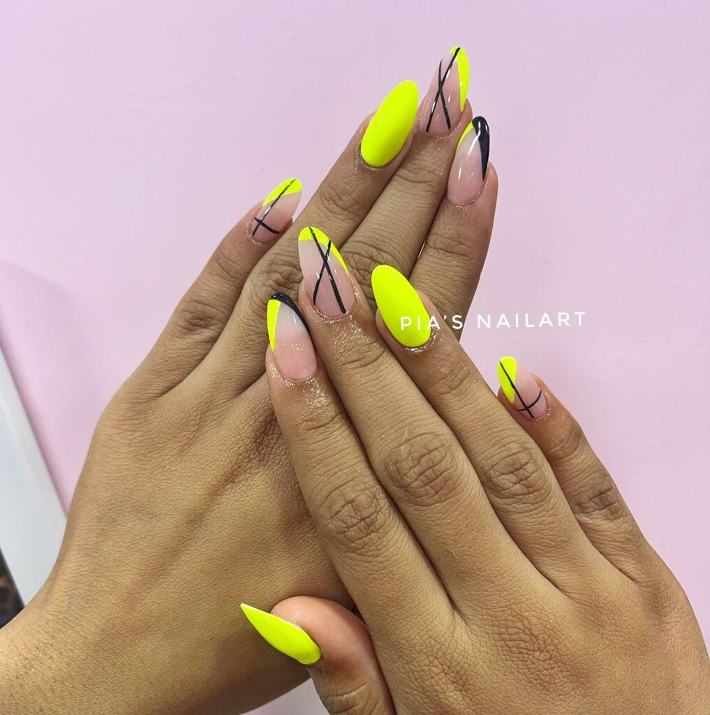 Edgy Neon Yellow Almond Nails With Black Line Design