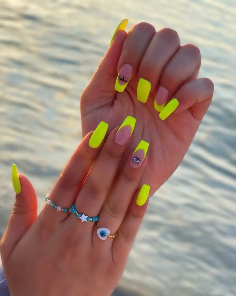 Eye-Catching Neon Yellow Coffin Nails With Eye Of Ra Design