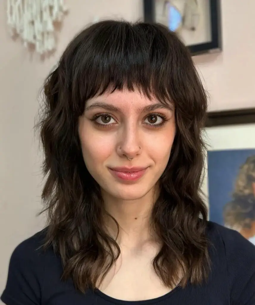 Medium-Length Hairstyles with Bangs: Get Wavy Chic with a Shag and Arched Bangs