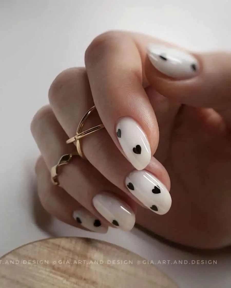 Milky White Almond Nails with Black Hearts