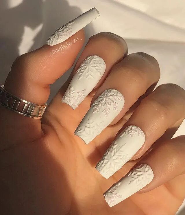 Winter Nail Designs | Elegant White Nails Adorned with Embossed Snowflakes