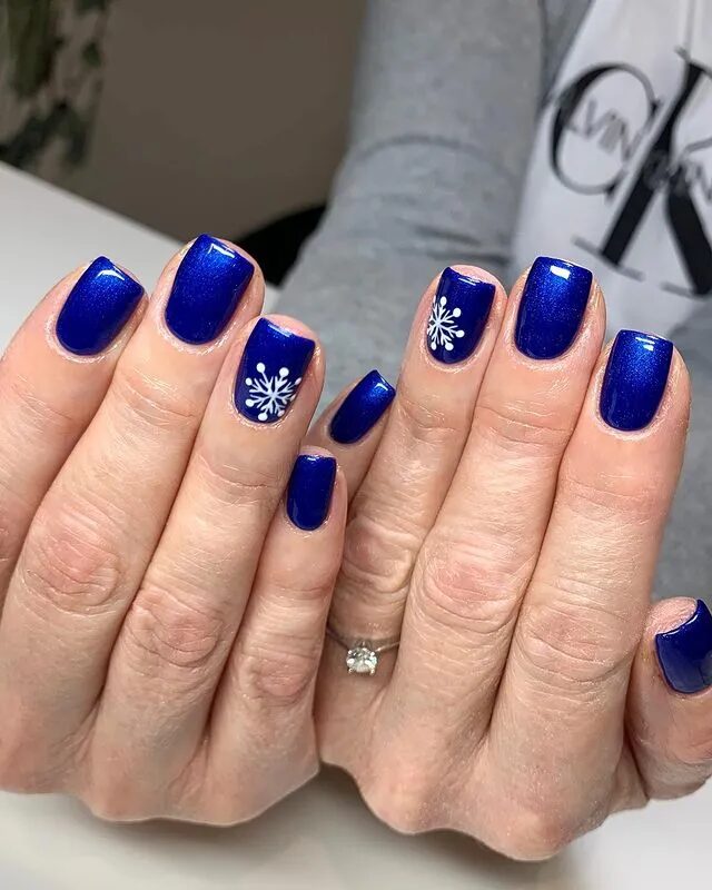 Winter Nail Designs | Vibrant Electric Blue Nails Adorned with Snowflake Art