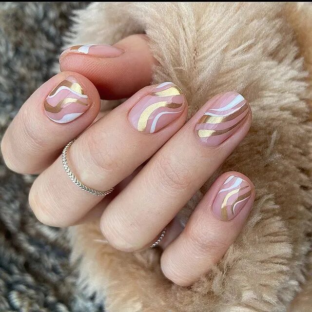 Winter Nail Designs | Glamorous Gold Chrome and White Swirl Nails for a Chic Look