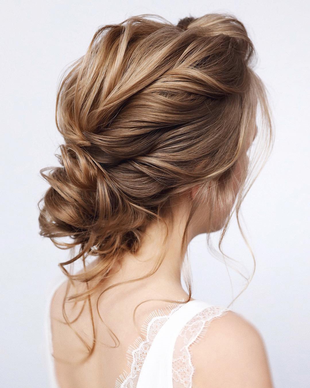 wedding hairstyles for medium hair low curly bun with loose curls tonyastylist